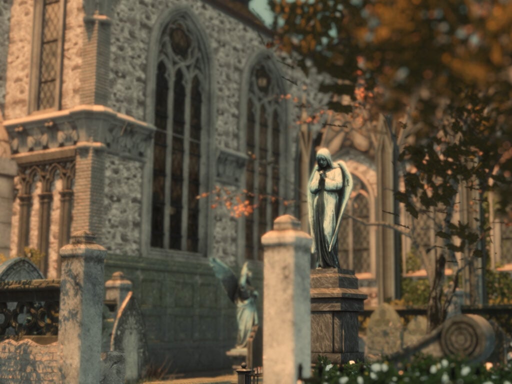 Iglesia gótica con estatua de ángel en el cementerio.