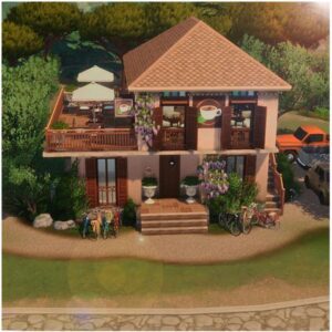 Maison à étages du jeu *Les Sims 4* avec café et vélos